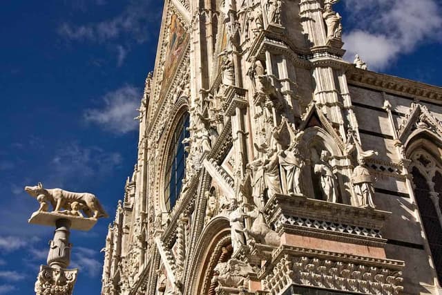 The facade of Siena Cathedral in black and white marble